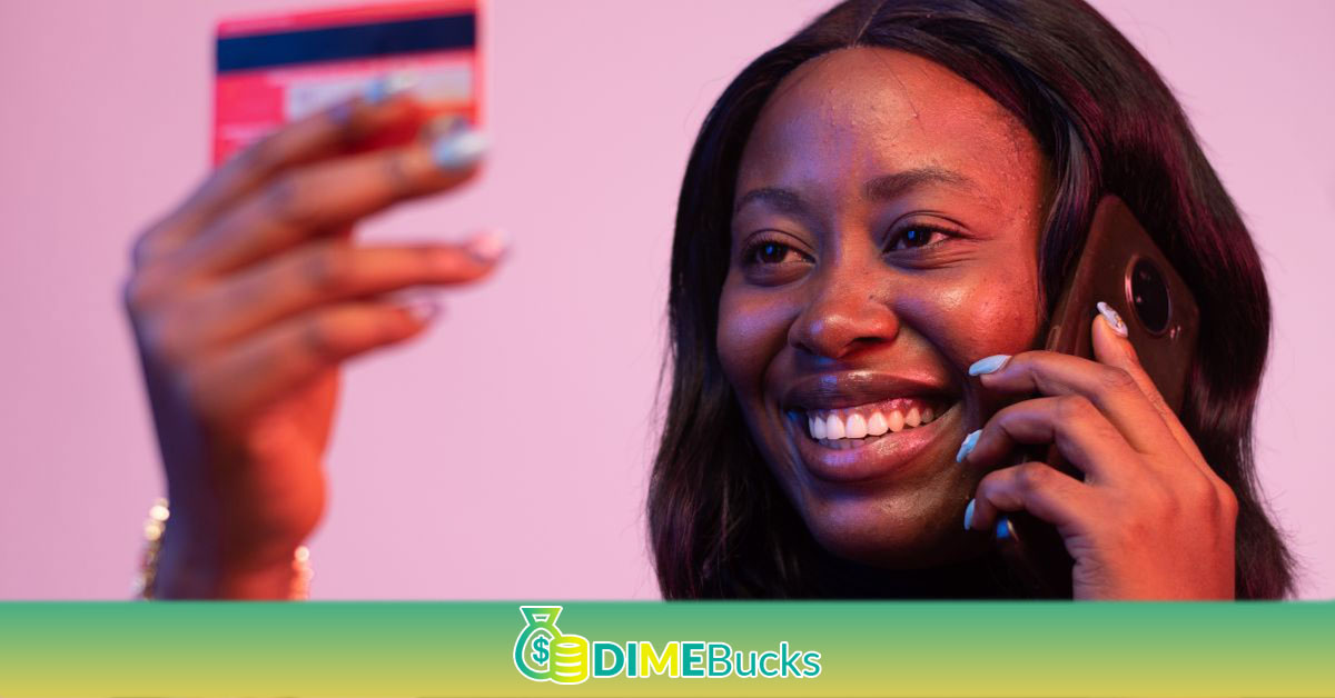 lady holding a credit card and making a phone call