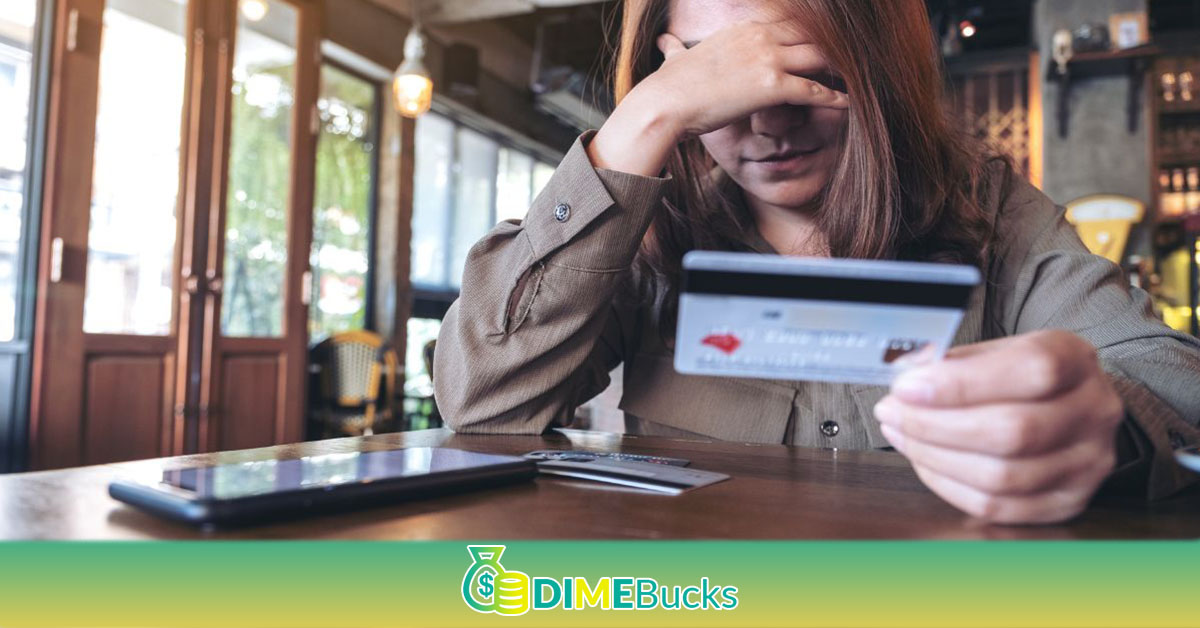 Stressed woman holding her credit card