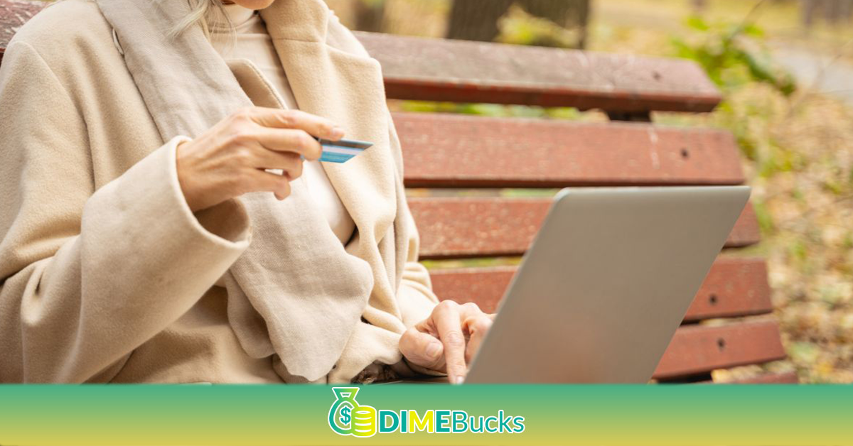 Focused woman looking at her debit card
