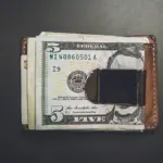 a wallet with a dollar bill sticking out of it